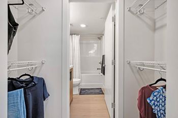 A white bathroom with a toilet, sink, and shower.at Skyway Apartments, Calgary
